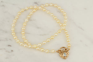 MODERN AKOYA SINGLE STRAND NECKLACE WITH 9ct TOPAZ SET HEART PADLOCK CLOSURE