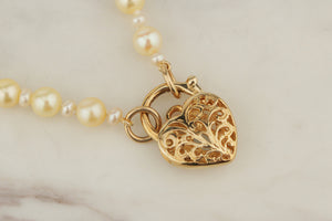 MODERN AKOYA SINGLE STRAND NECKLACE WITH 9ct TOPAZ SET HEART PADLOCK CLOSURE