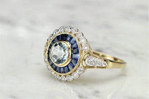 MODERN AQUAMARINE SAPPHIRE AND DIAMOND TARGET RING ON 9ct YELLOW GOLD