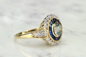 MODERN AQUAMARINE SAPPHIRE AND DIAMOND TARGET RING ON 9ct YELLOW GOLD