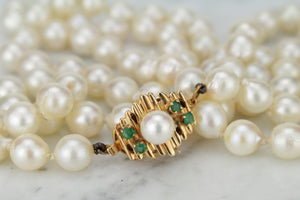 ESTATE VINTAGE SEMI-BAROQUE PEARL STRAND WITH EMERALD SET CLASP ON 14ct YELLOW GOLD