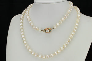 ESTATE VINTAGE SEMI-BAROQUE PEARL STRAND WITH EMERALD SET CLASP ON 14ct YELLOW GOLD